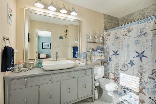 bathroom with toilet, vanity, tile patterned floors, and walk in shower