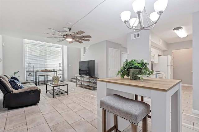 interior space with ceiling fan with notable chandelier