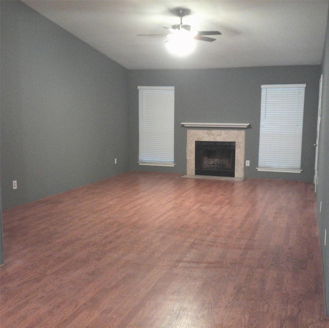 unfurnished living room featuring ceiling fan and dark hardwood / wood-style floors