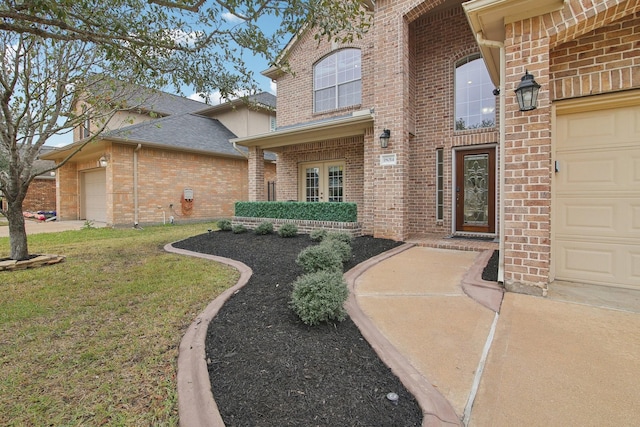 doorway to property featuring a garage and a yard