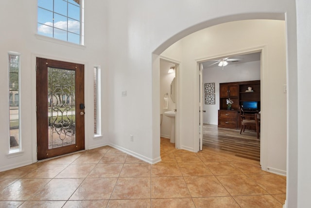 entryway featuring ceiling fan and light tile patterned floors