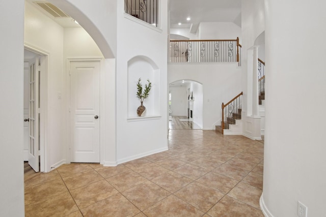 tiled foyer entrance with a high ceiling