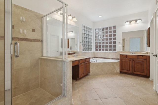 bathroom featuring tile patterned floors, vanity, and independent shower and bath