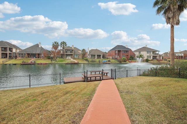 view of dock featuring a water view and a lawn