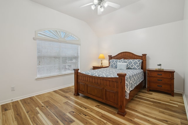 bedroom with ceiling fan, light hardwood / wood-style flooring, and vaulted ceiling