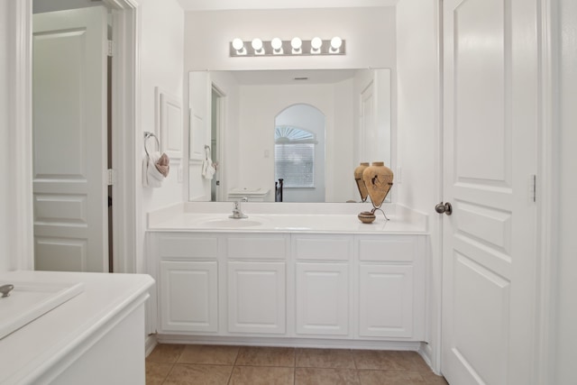 bathroom with tile patterned floors and vanity