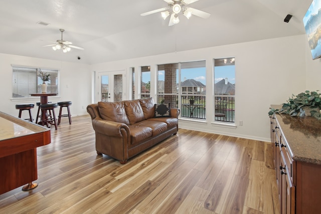 living room featuring light wood-type flooring, ceiling fan, and lofted ceiling