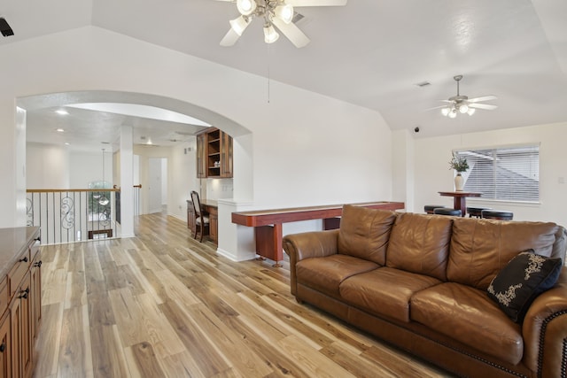 living room with light hardwood / wood-style floors, plenty of natural light, ceiling fan, and vaulted ceiling