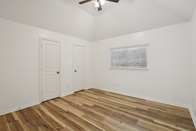 unfurnished bedroom featuring ceiling fan, vaulted ceiling, and light hardwood / wood-style floors