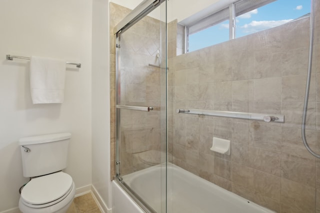 bathroom featuring toilet and enclosed tub / shower combo