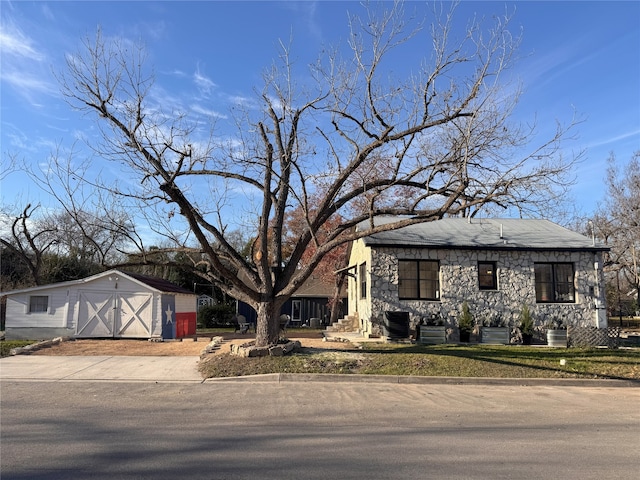 view of front of home featuring a storage shed