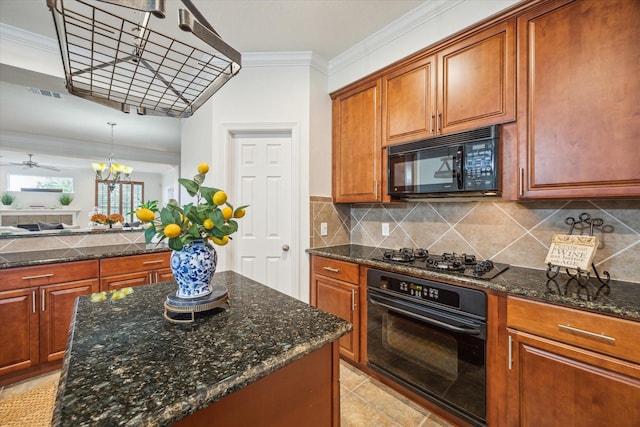 kitchen with tasteful backsplash, pendant lighting, crown molding, ceiling fan with notable chandelier, and black appliances