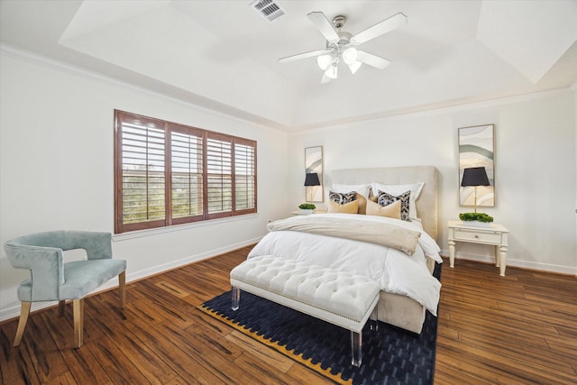 bedroom with ceiling fan, dark hardwood / wood-style floors, ornamental molding, and a raised ceiling