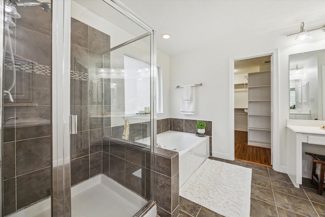 bathroom featuring vanity, tile patterned flooring, and shower with separate bathtub