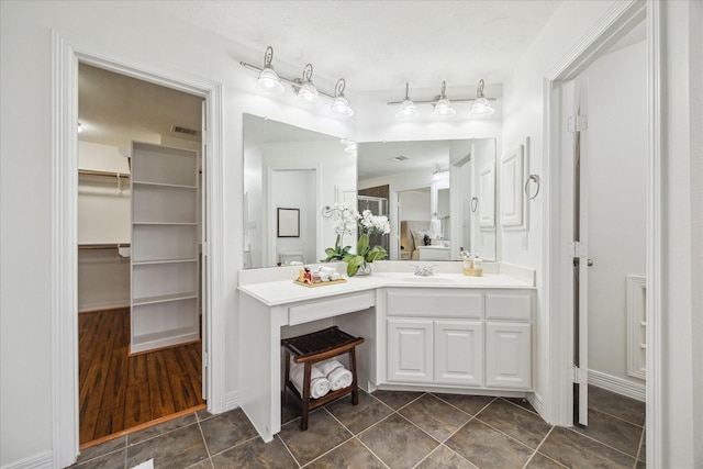 bathroom with tile patterned flooring and vanity