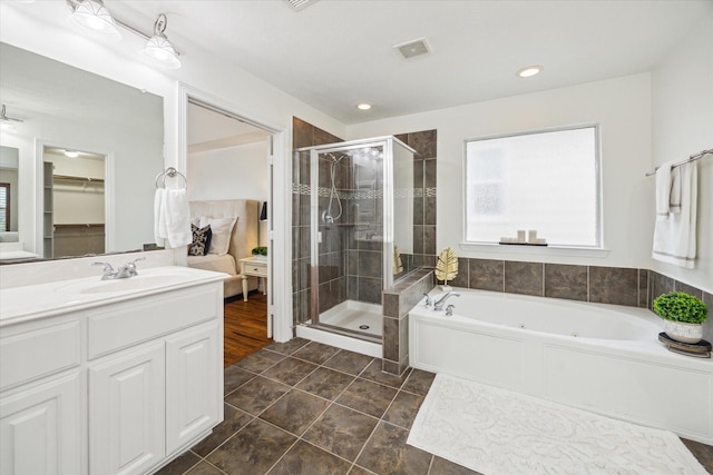 bathroom with tile patterned flooring, vanity, and shower with separate bathtub