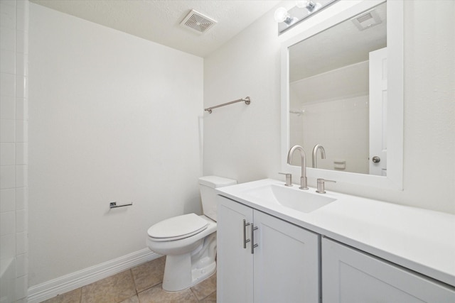 bathroom with tile patterned floors, toilet, vanity, and walk in shower