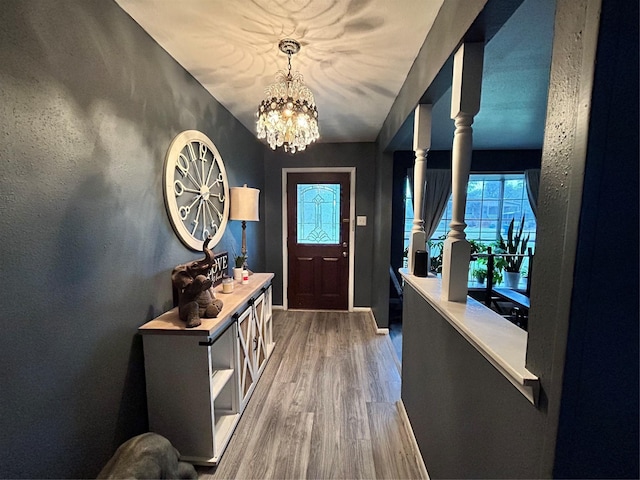 entrance foyer featuring hardwood / wood-style flooring and a notable chandelier