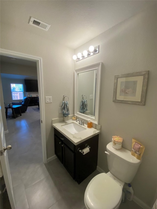 bathroom with toilet and vanity