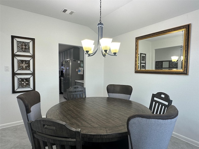 dining space featuring lofted ceiling and an inviting chandelier