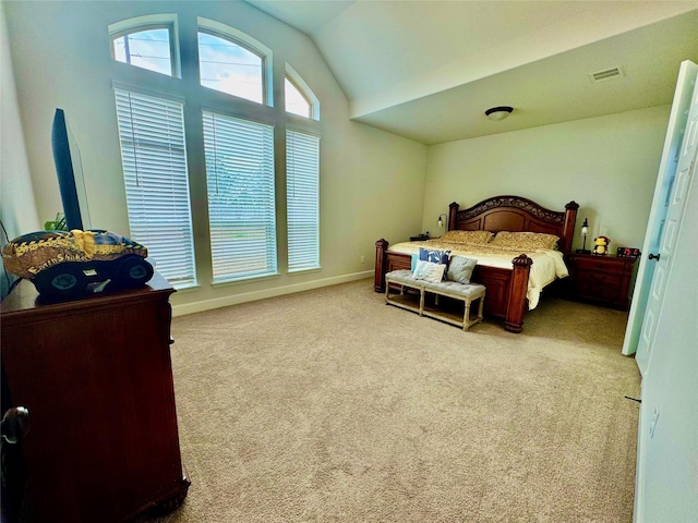 carpeted bedroom with vaulted ceiling