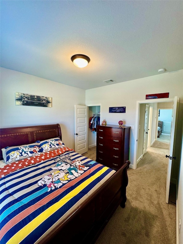 carpeted bedroom with a closet