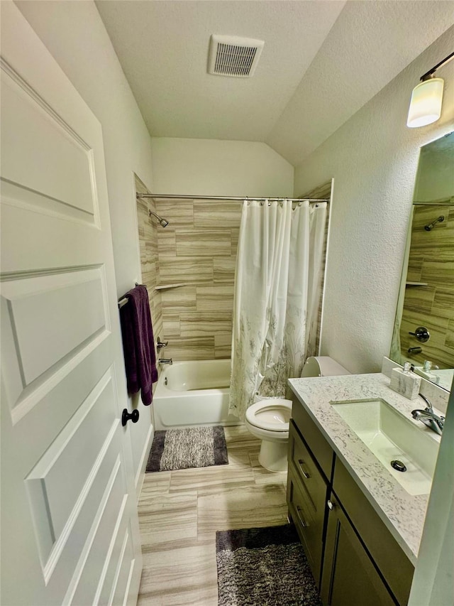 full bathroom featuring toilet, shower / bath combo, lofted ceiling, a textured ceiling, and vanity