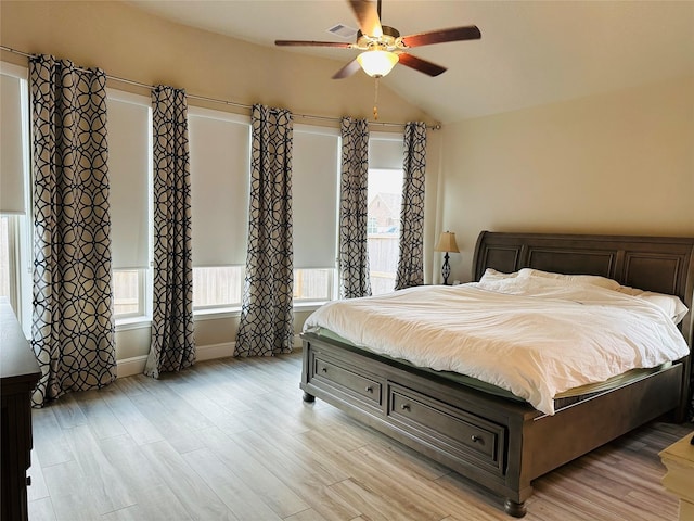 bedroom with lofted ceiling, light wood-type flooring, and ceiling fan