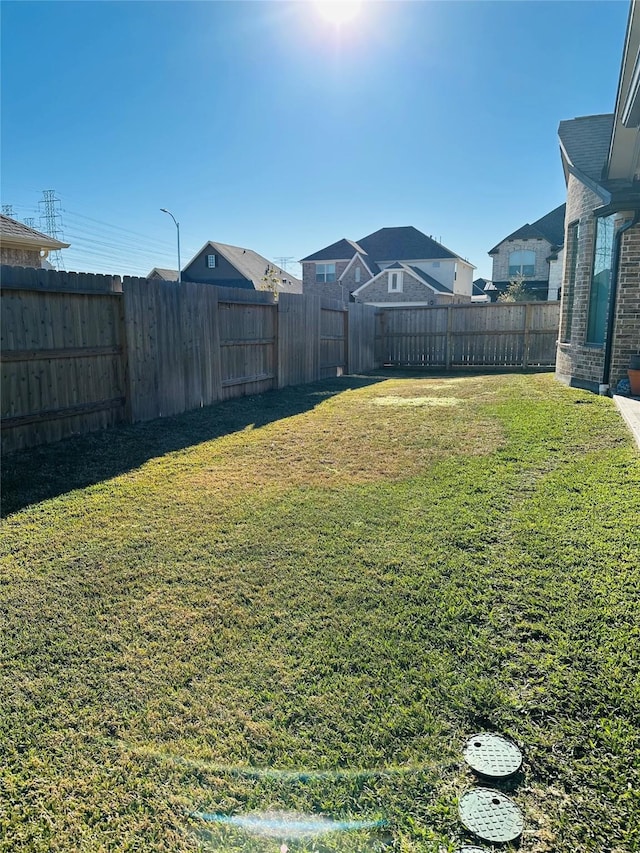 view of yard with a fenced backyard