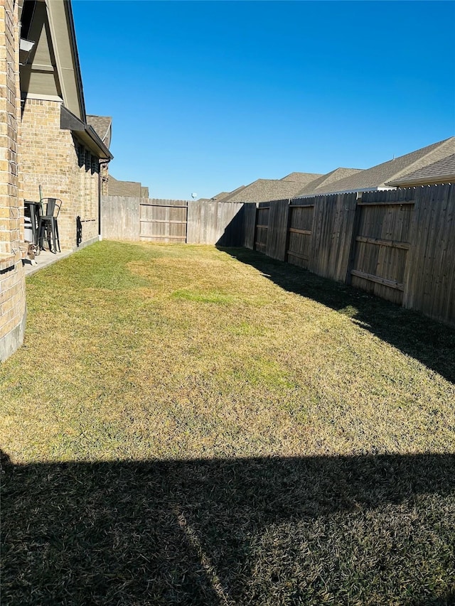 view of yard with a fenced backyard