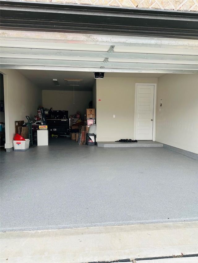 garage with baseboards and a garage door opener