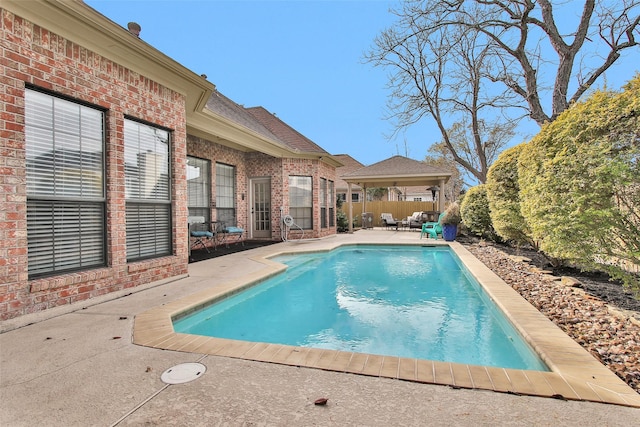 view of swimming pool featuring a patio and a gazebo