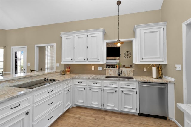 kitchen featuring decorative light fixtures, sink, white cabinets, black electric stovetop, and stainless steel dishwasher