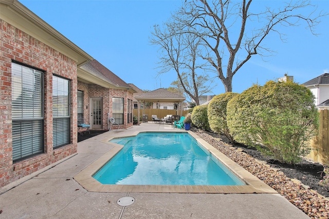 view of swimming pool featuring a gazebo and a patio area