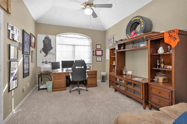 home office featuring lofted ceiling, light carpet, and ceiling fan