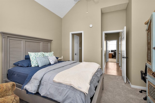 carpeted bedroom featuring high vaulted ceiling