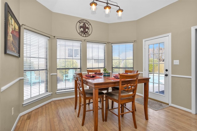 dining space featuring plenty of natural light and light hardwood / wood-style flooring