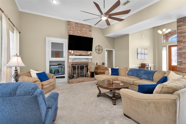 living room with ornamental molding, a fireplace, ceiling fan with notable chandelier, and light carpet