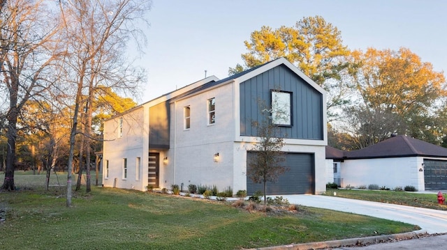 contemporary house featuring a garage and a front lawn