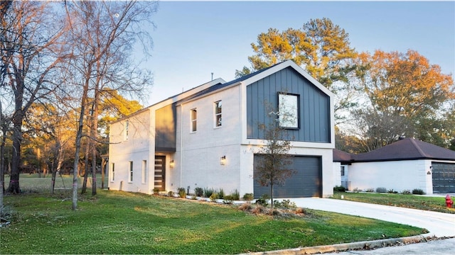 contemporary home with a garage and a front lawn