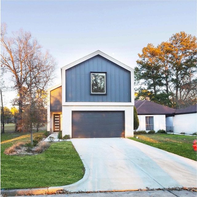 view of front facade with a garage and a front lawn