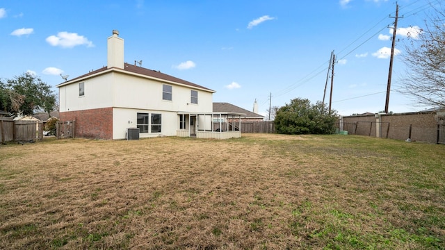 back of house with a lawn and cooling unit