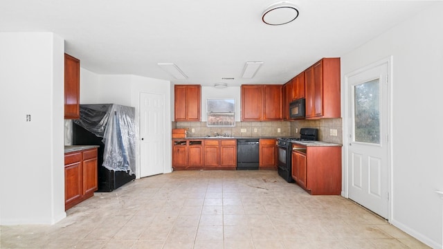 kitchen featuring decorative backsplash, sink, and black appliances