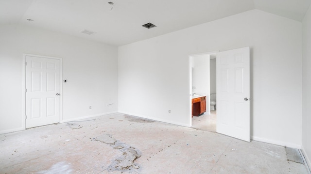 unfurnished room featuring lofted ceiling