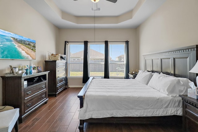 bedroom featuring a tray ceiling and ceiling fan