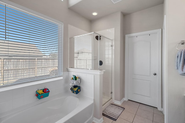 bathroom with separate shower and tub and tile patterned flooring