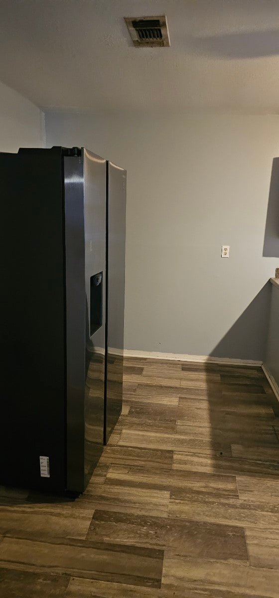 kitchen featuring stainless steel refrigerator with ice dispenser and dark hardwood / wood-style flooring