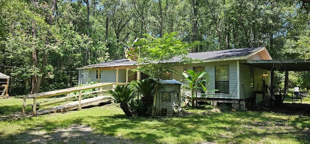 exterior space featuring a carport and a front yard