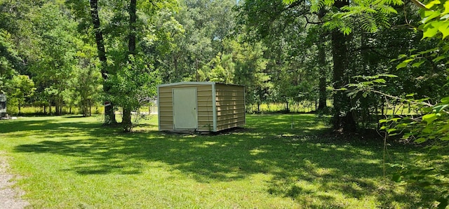 view of outdoor structure featuring a lawn