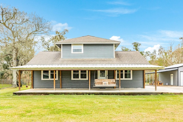 rear view of property featuring a yard